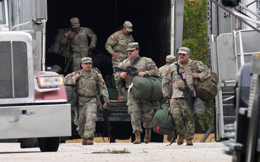 Military personnel in uniform, with the Texas National Guard patch on, are seen at the U.S. Army Reserve Center.