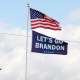 A "Let's go Brandon" flag flies below the American flag.