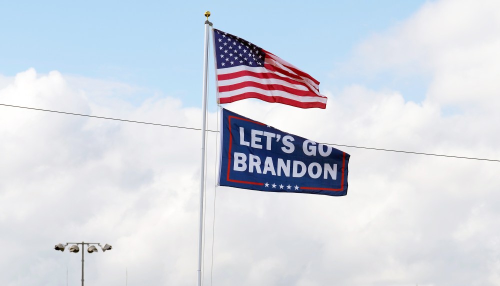 A "Let's go Brandon" flag flies below the American flag.