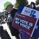 Demonstrators hold signs in support of minority voting rights outside the U.S. Supreme Court on.