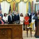 President Donald Trump listens as Sen. Katie Britt, R-Ala., speaks in the Oval Office of the White House.