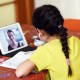 Child participates in remote learning lessons with her teacher.