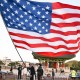 An American flag being waved during a rally.