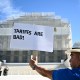A demonstrator holds up a sign reading "Tariffs are bad" outside the Supreme Court on Nov. 5, 2025.