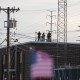 People on the roof of the immigration processing and detention center watch demonstrators in Broadview, I.L.