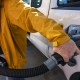 A customer refuels his car at a gas station.