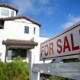 A for sale sign is displayed outside of a home.