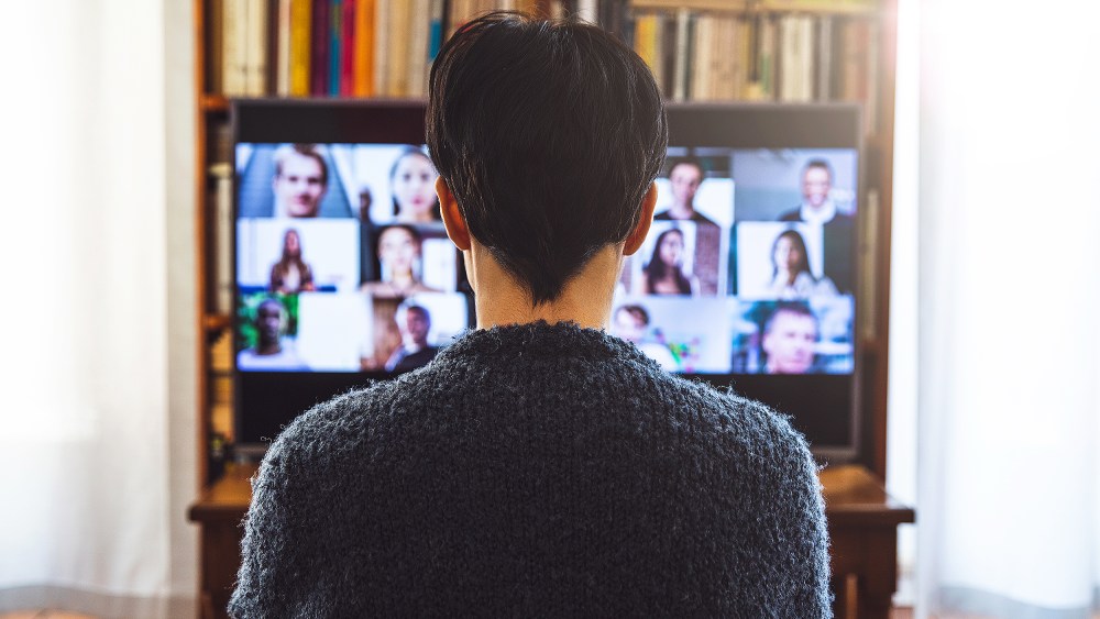 Woman in front of a device screen in video conference for work.