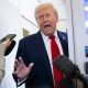 President Donald Trump speaks with the media aboard Air Force One.