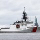 A Coast Guard ship sails past the Statue of Liberty.