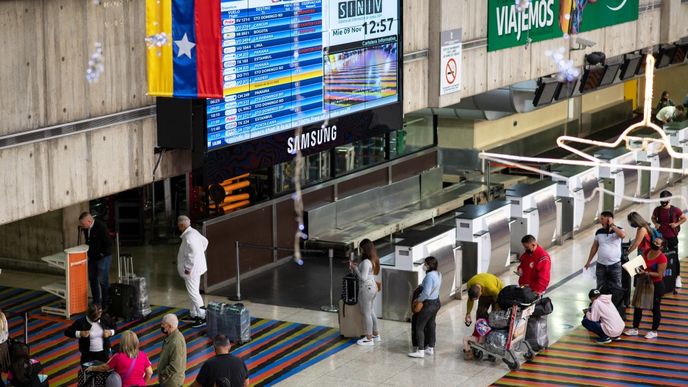 Travelers wait in line to check in for flights at the Simón Bolívar International Airport in Venezuela.