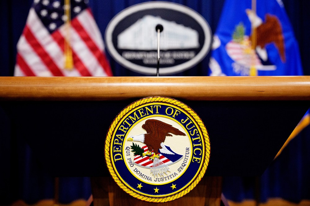 The Department of Justice seal and logo are displayed at the Department of Justice.
