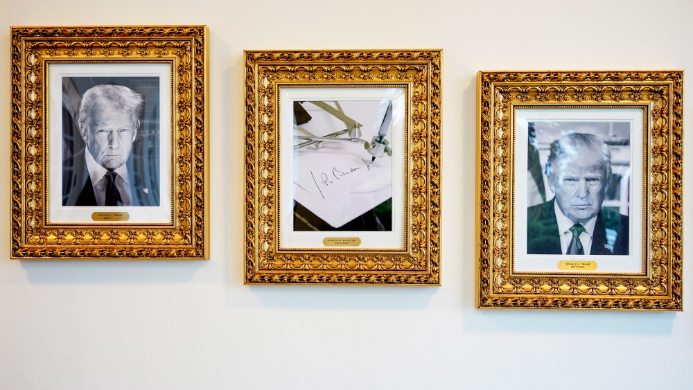 Framed portraits of President Donald Trump flank an image of former President Joe Biden's signature and an autopen along "The Presidential Walk of Fame" at the White House.