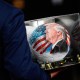 A person carries a soccer ball with a painting of President Donald Trump in D.C.