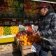 A man walks by a food market in New York City.