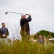 President Donald Trump, accompanied by his son Eric, left, tees off at a new 18-hole course at Trump International Golf Links on July 29, 2025, in Balmedie, near Aberdeen, Scotland.