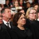 Justice Elena Kagan sits between Chief Justice of the Supreme Court John Roberts and Justice Brett Kavanaugh.