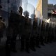 National guards stand in front of the entrance of the Metropolitan Detention Center as demonstrators gather in front of it following federal immigration operations in Los Angeles, CA.