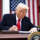 President Donald Trump signs an executive order on April 2, 2025, in the Rose Garden of the White House.