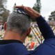 A man touches his kippah during a menorah lighting ceremony at a floral memorial for victims of the Bondi Beach shooting on Dec. 16, 2025 in Sydney, Australia.