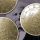 One Dollar coins featuring Trump's likeness overlaying a picture of Frederick Douglass