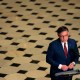 An aerial view of Speaker of the House Mike Johnson as he holds a news conference surrounded by the checkered floor of the Capitol.