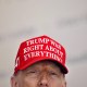 President Donald Trump wears a hat that reads "Trump was right about everything."