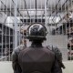 A prison officer guards a cell at the maximum-security penitentiary CECOT on April 4, 2025, in El Salvador.