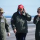 President Donald Trump observes naval flight demonstrations on the deck of the USS George H.W. Bush aircraft carrier.