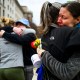 Prarie Summer, a USAID contractor for almost 10 years, right, cries as she embraces a Alexandra Jung after leaving the agency's former offices at the Ronald Reagan Building and International Trade Center.