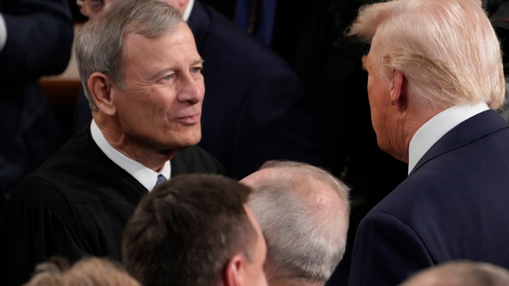 President Donald Trump greets Chief Justice John Roberts before he addresses a joint session of Congress at the U.S. Capitol.