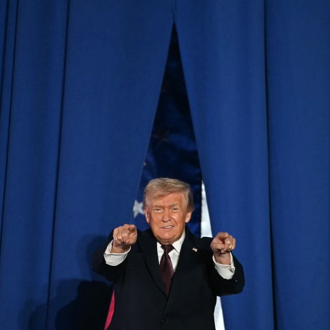 U.S. President Donald Trump steps on stage to speak at a political rally.