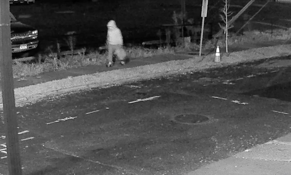 Seen in a surveillance footage, the pipe bomber case suspect is walking in the Capitol Hill neighborhood, wearing a hoodie.