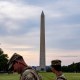 Two National Guardsmen walk in front of the Washington Monument