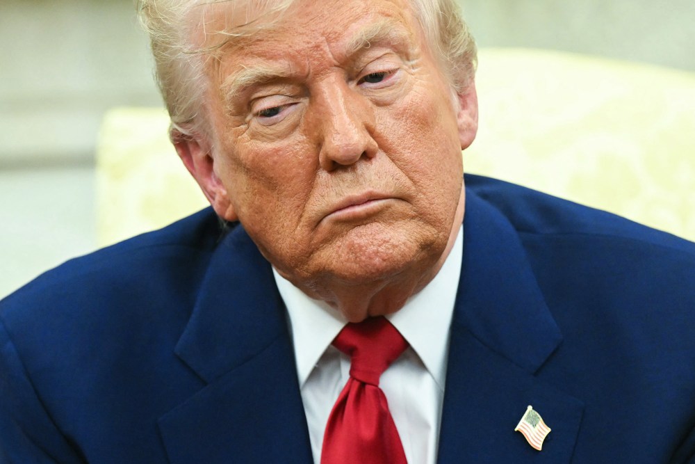 Donald Trump looks down.