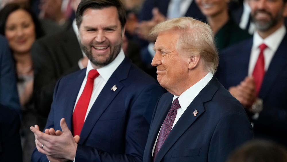 Vice President JD Vance claps as President Donald Trump smiles.