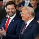 Vice President JD Vance claps as President Donald Trump smiles.
