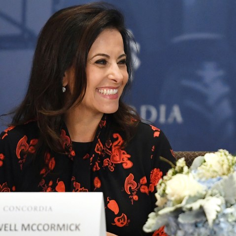 Dina Powell McCormick smiles.
