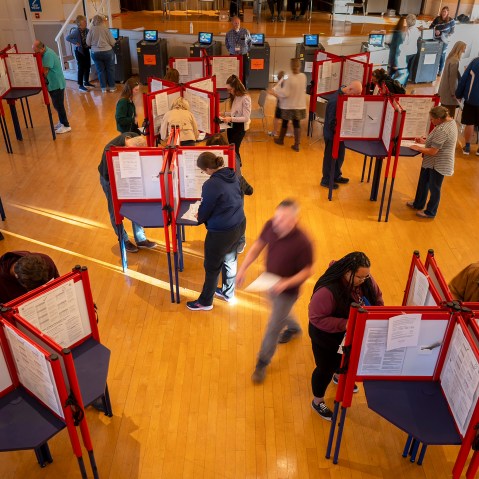 An aerial photo of people filling in ballots.