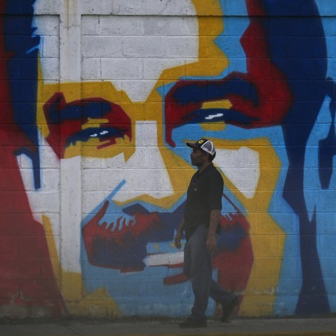 A man walks past a graffiti depicting Venezuelan President Nicolas Maduro in Caracas on January 3, 2026.