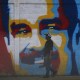 A man walks past a graffiti depicting Venezuelan President Nicolas Maduro in Caracas on January 3, 2026.