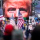 President Trump's closeup photo seen on video screens in front of a crowd at a rally.