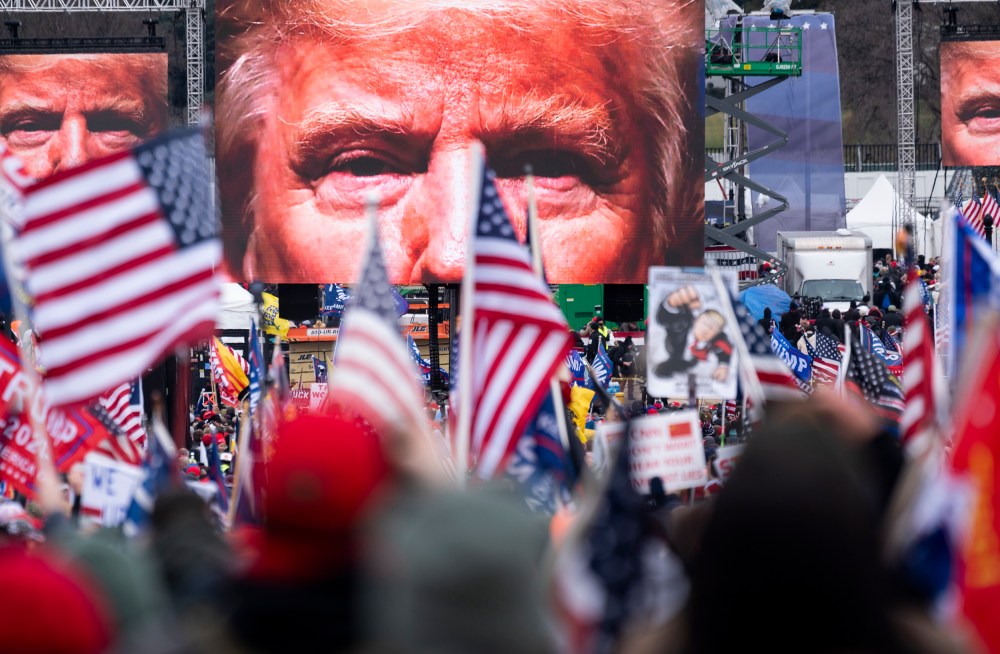 President Trump's closeup photo seen on video screens in front of a crowd at a rally.