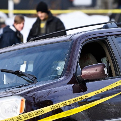 Police tape surrounds a vehicle suspected to be involved in a shooting by an ICE agent during federal law enforcement operations in Minneapolis, NM.