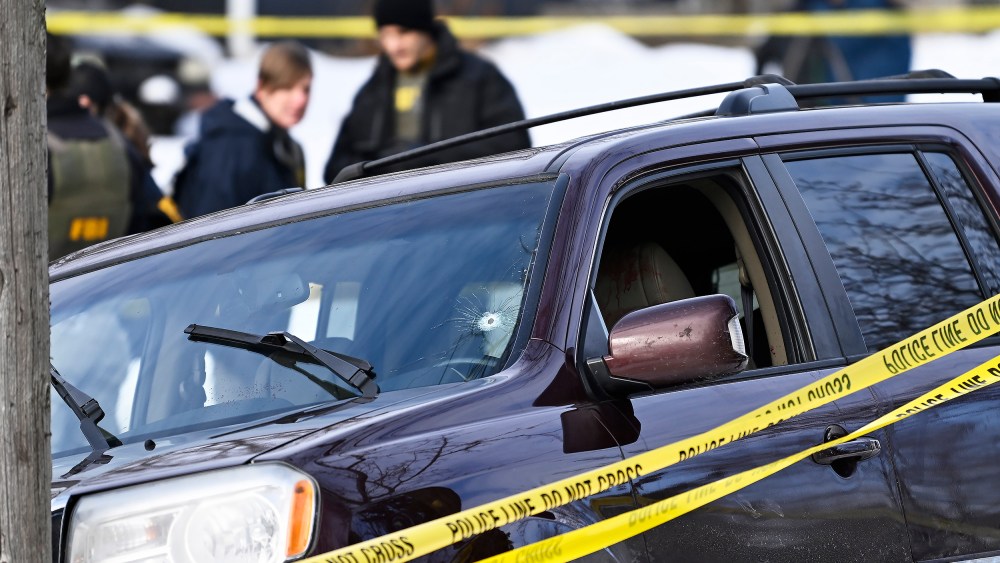 Police tape surrounds a vehicle suspected to be involved in a shooting by an ICE agent during federal law enforcement operations in Minneapolis, NM.