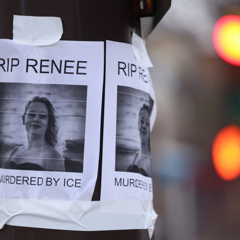 A photo of Renee Good is stapled on an electric pole.