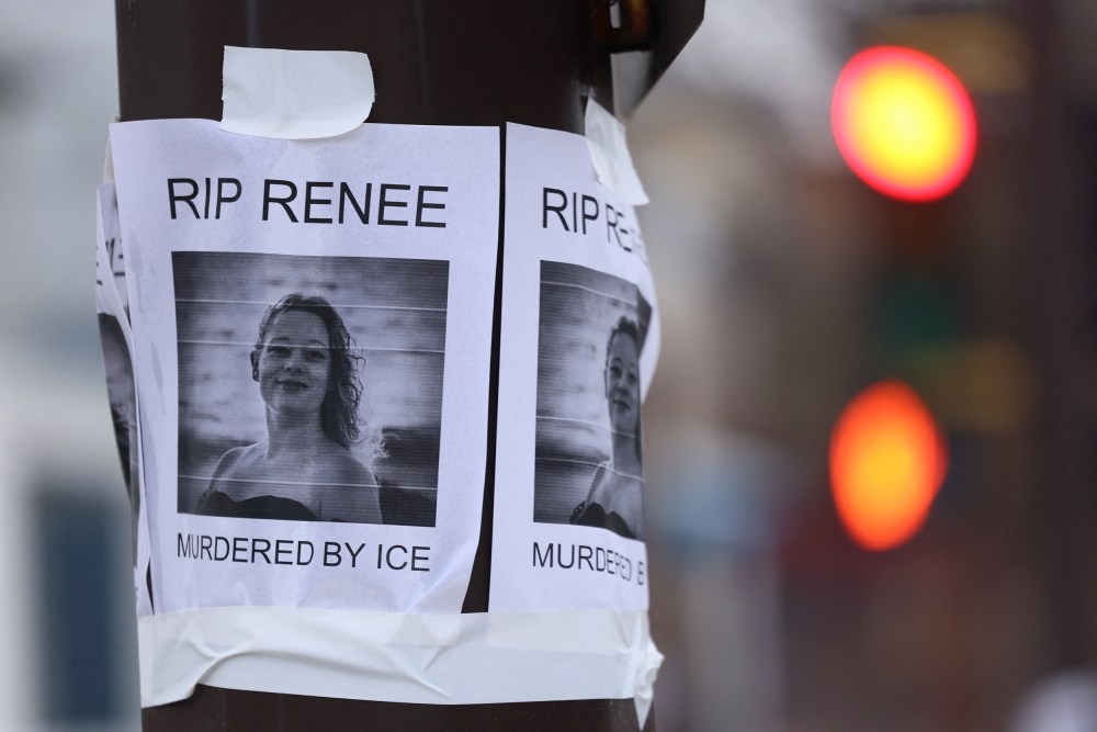 A photo of Renee Good is stapled on an electric pole.