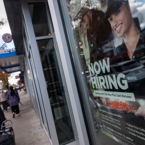 A &ldquo;Now Hiring&rdquo; sign is seen on a Chipotle window.