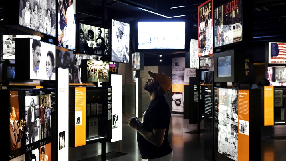 A man looks at the screens at the Smithsonian National Museum of African American History.