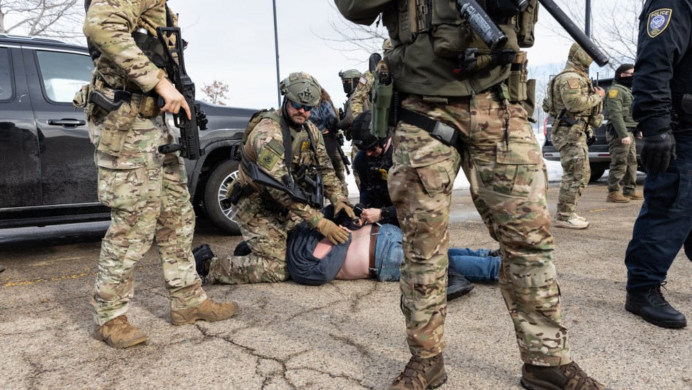 Federal agents arrest protestors outside an ICE facility in Minneapolis on Jan. 9.